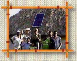 John From and Fijian family with solar panel on thatched hut